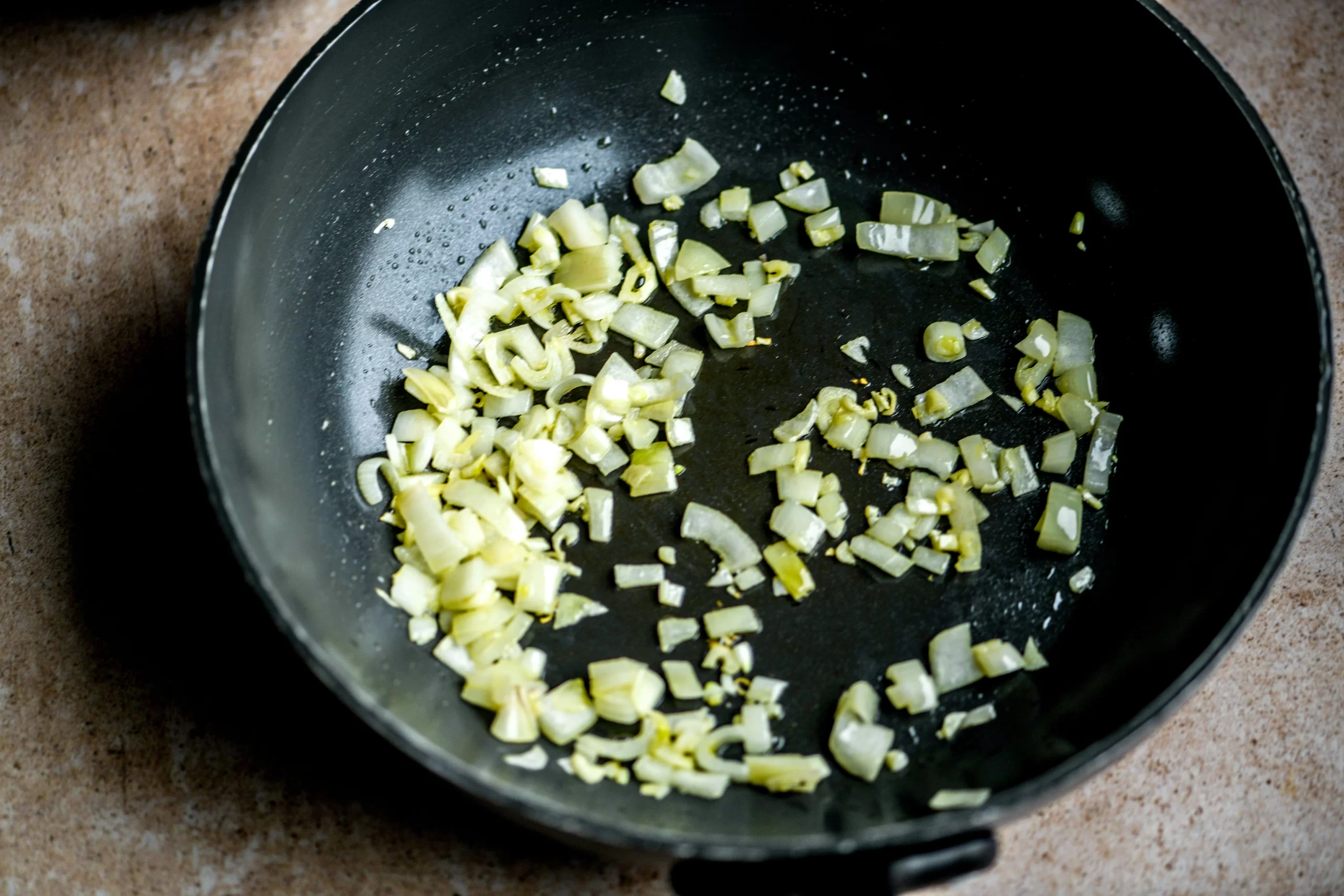 onions and garlic sautéeing in pan
