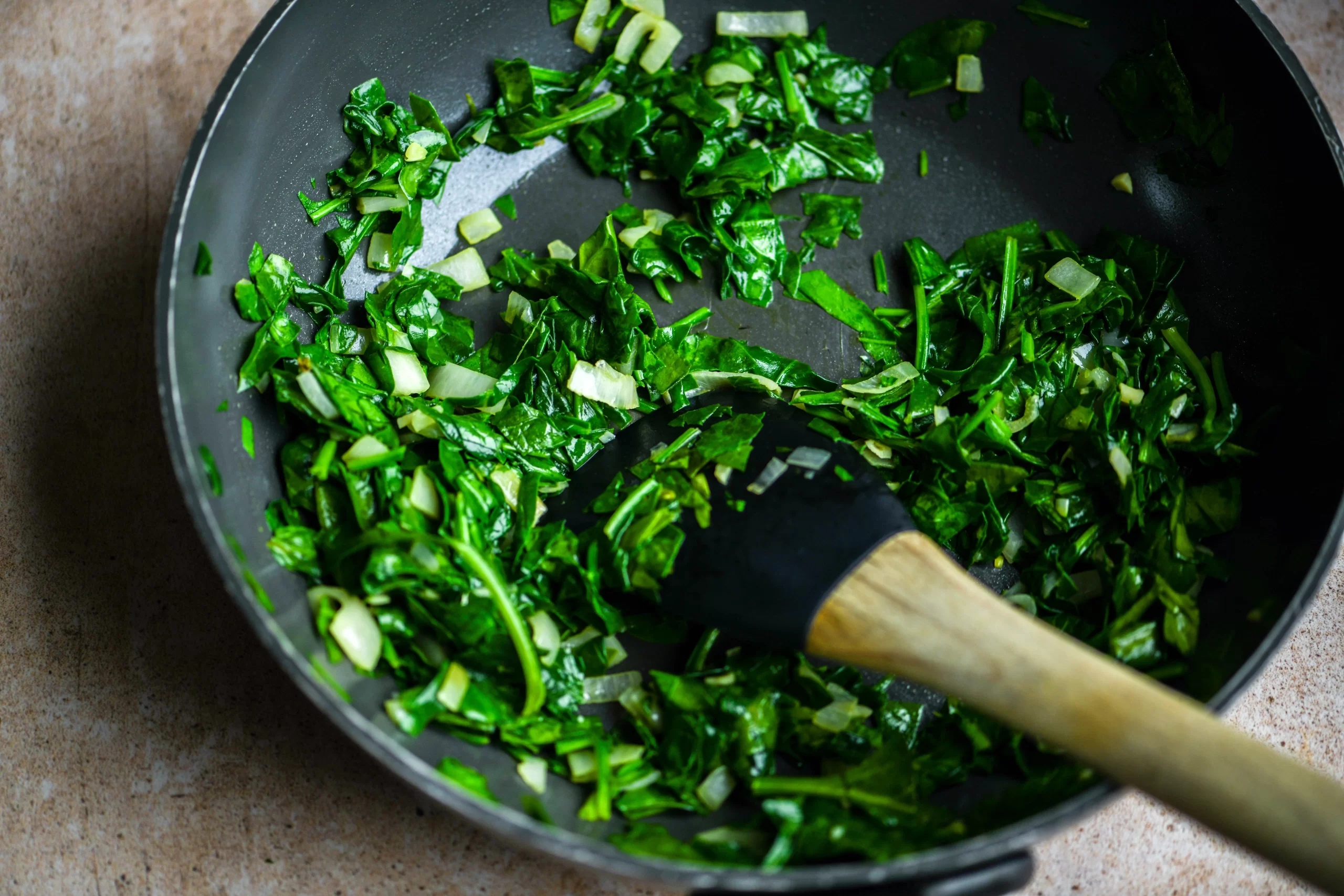 spinach sautéing in pan