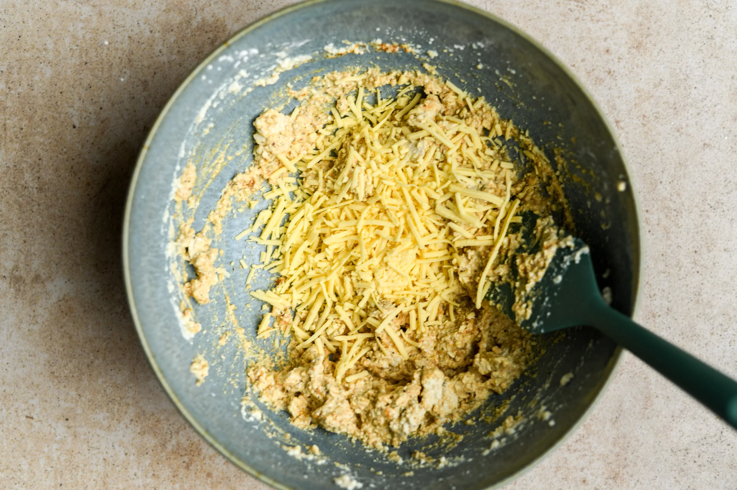 shredded vegan cheese added to bowl