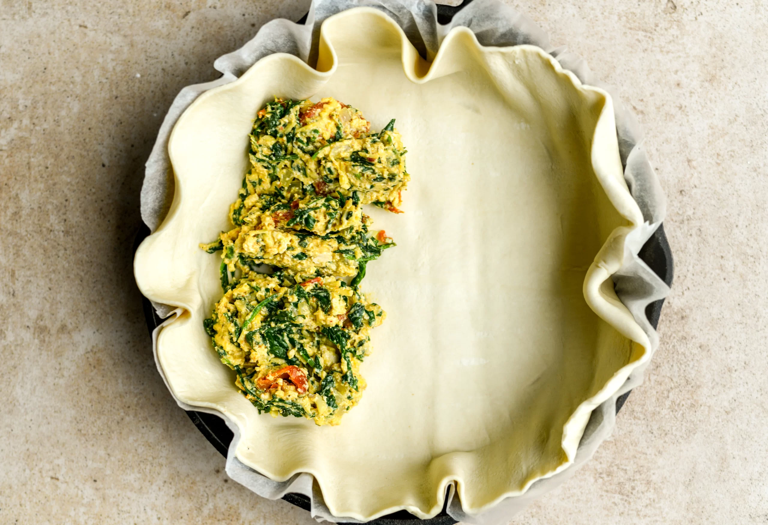 spinach pie filling added to pan