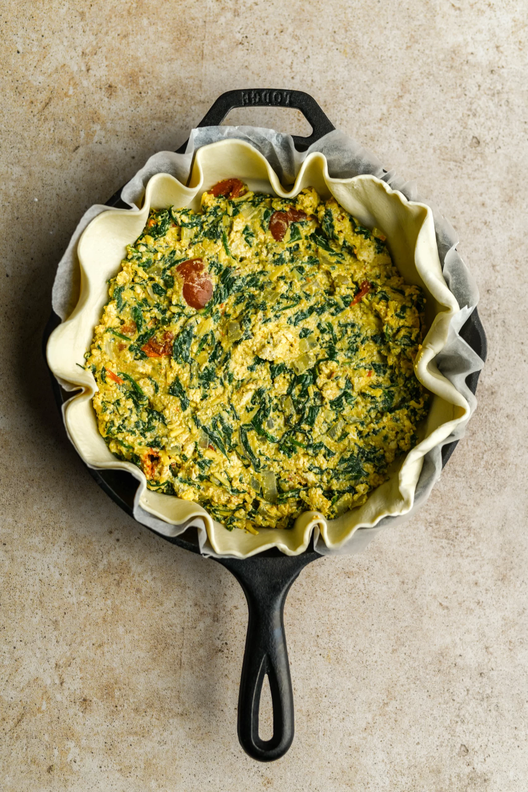 spinach pie filling added to pan