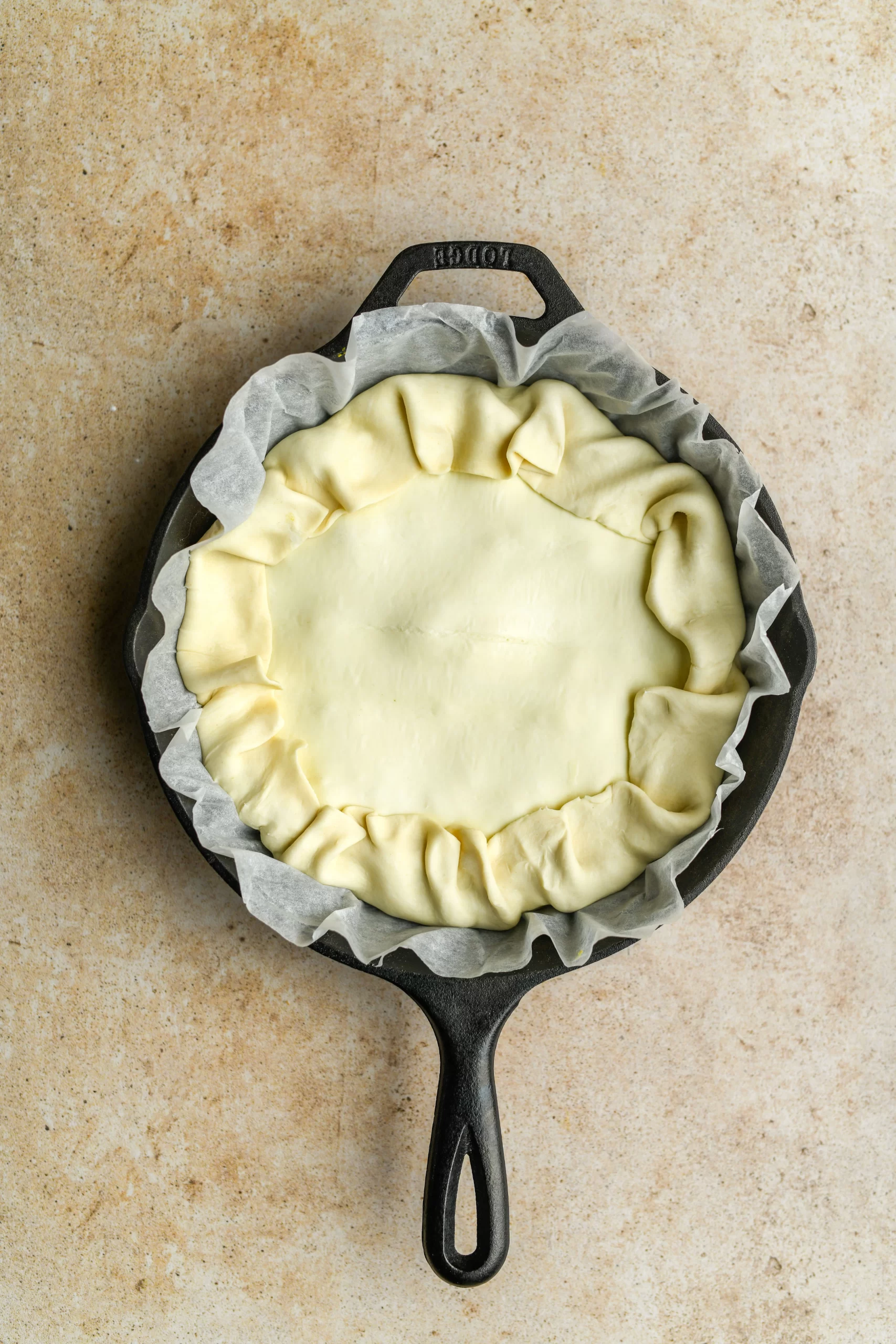 spinach pie filling added to pan topped with puff pastry